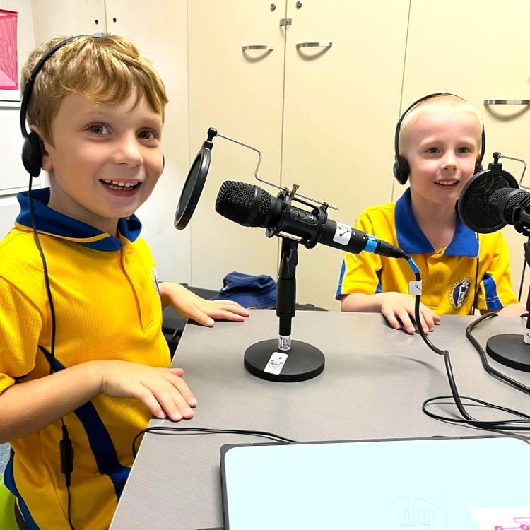 Two boys using the podcasting kit