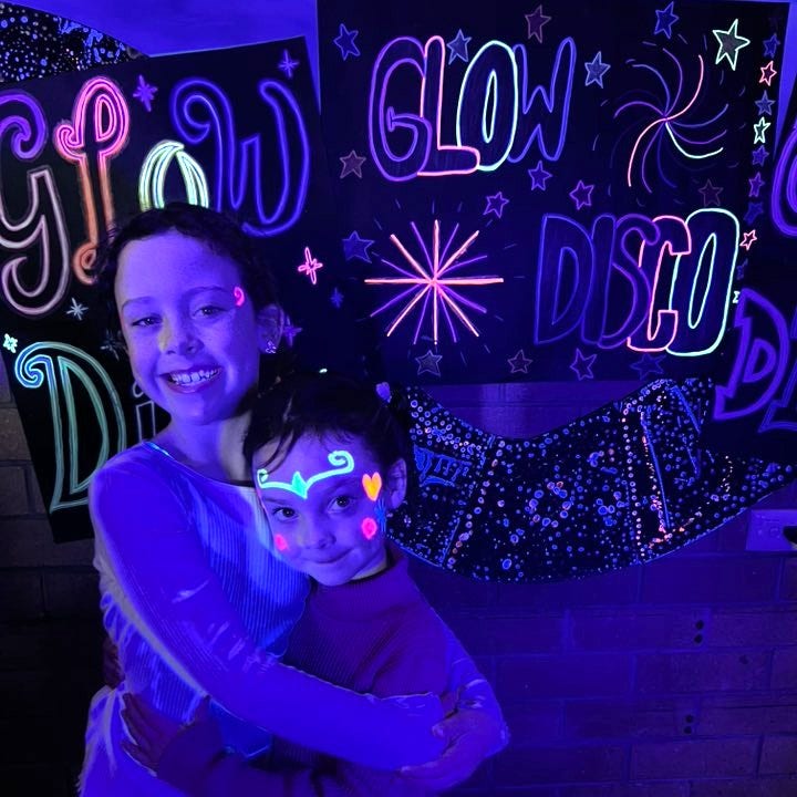 Two sisters posing for the glow disco