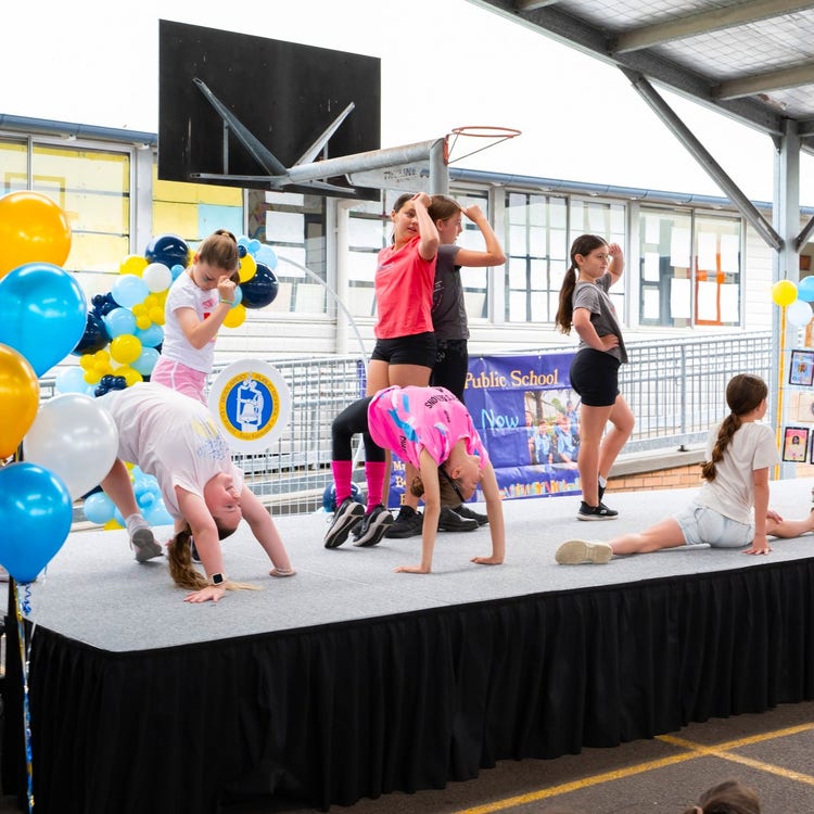 Dance group posing on stage