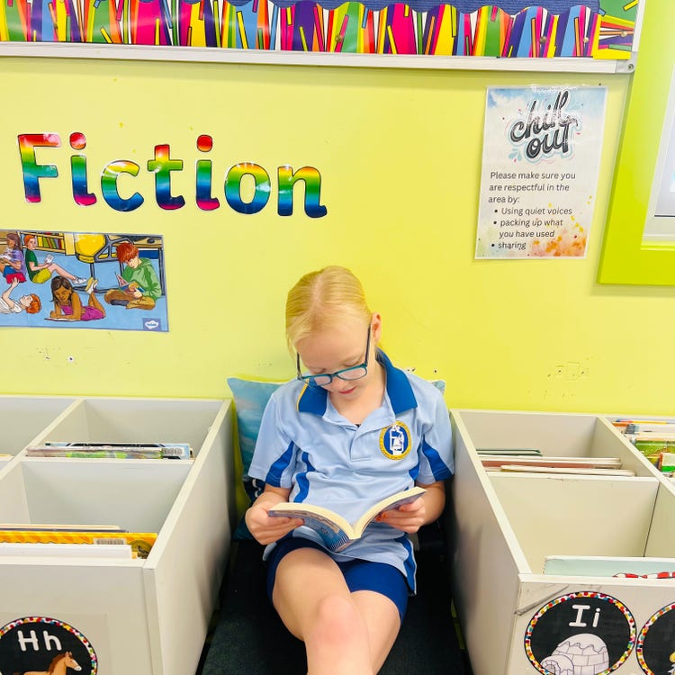 A girl reading a book in the library