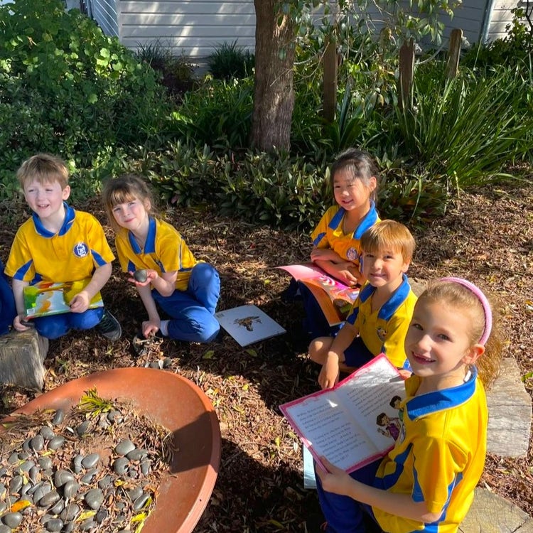 Students reading in the sensory garden
