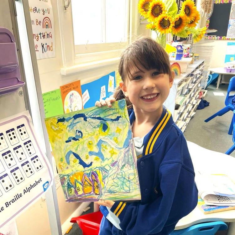 Year 1 student posing with artwork