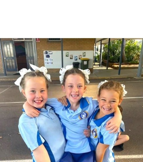 3 girls posing with each other in the playground
