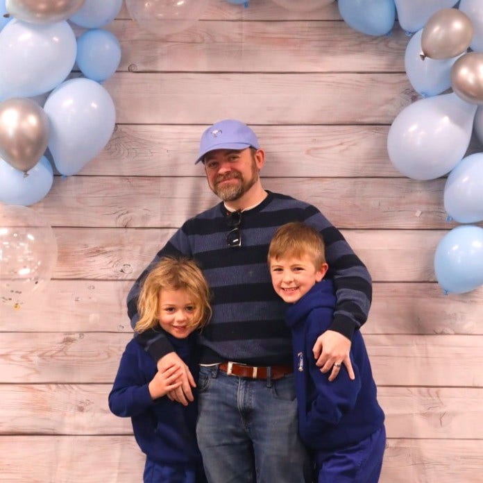 A dad and his 2 sons at the Father's Day breakfast